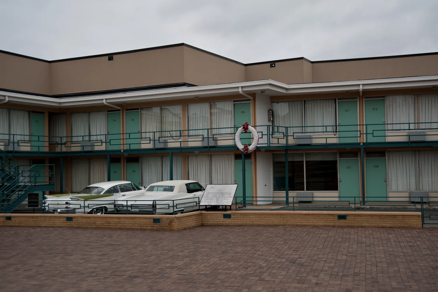 The Lorraine Motel facade, balcony and parked historic cars at the National Civil Rights Museum.
