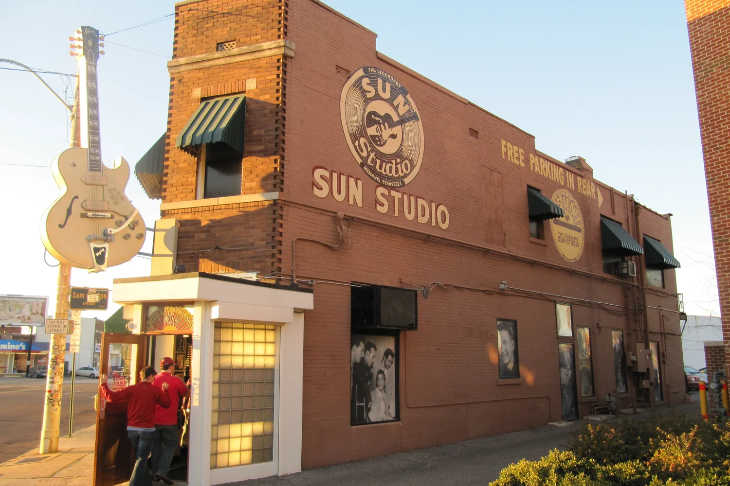 Sun Studio’s brick corner facade with its guitar sign in warm afternoon light.