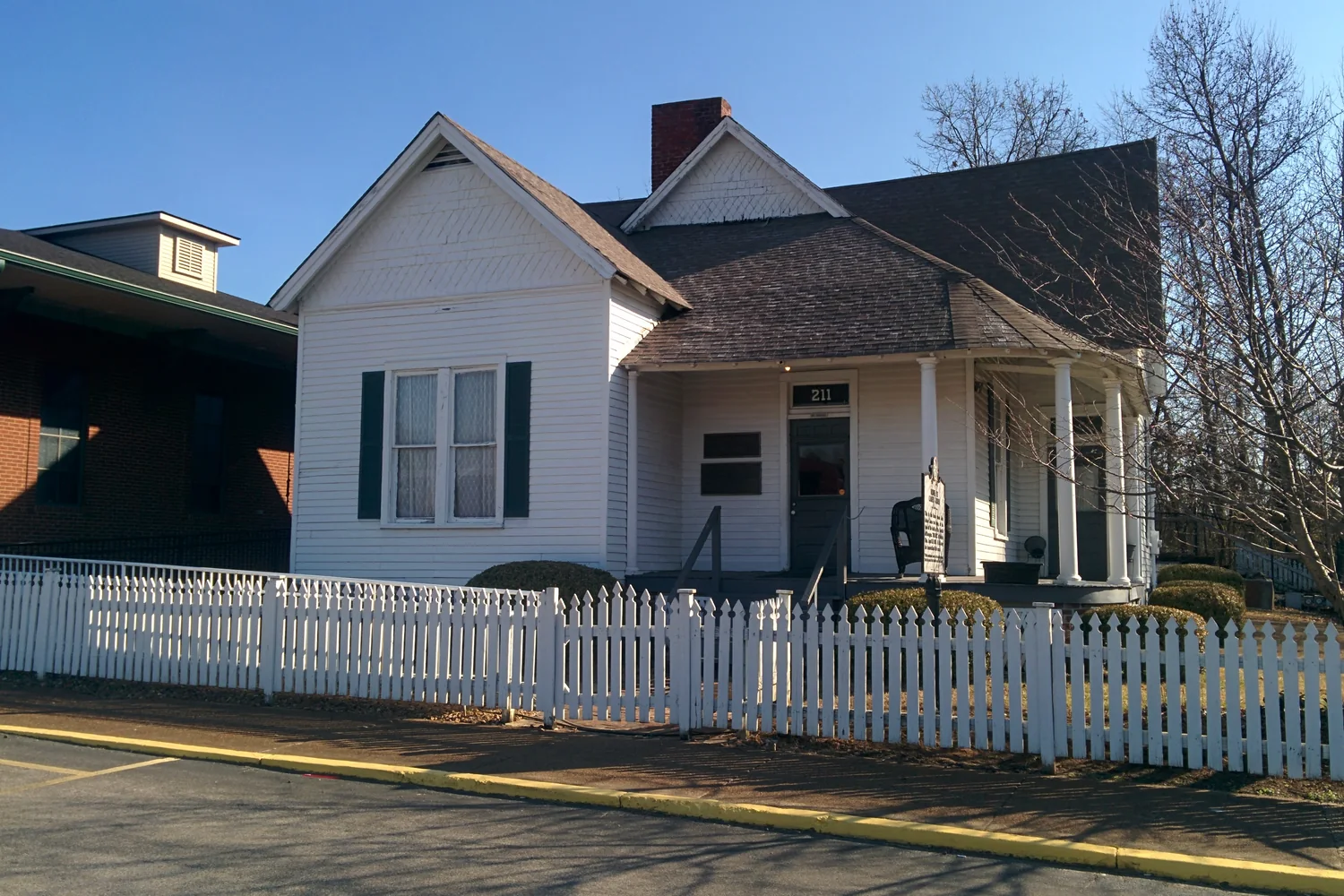 Casey Jones’s white historic home behind a white picket fence in Jackson.